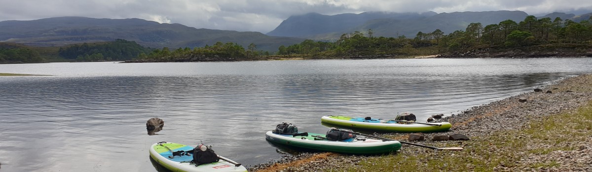 Red SUP paddling on Loch Maree 3 1200×350